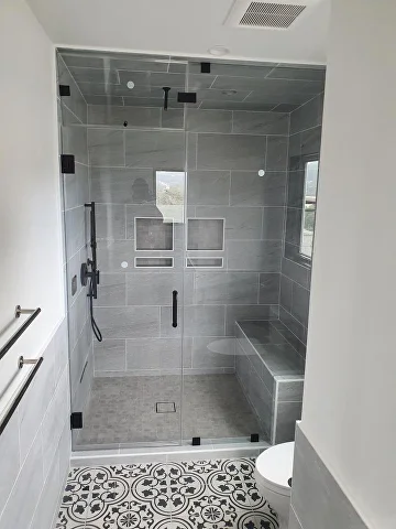 Walk-in tile shower · patterned floor in Bay Area